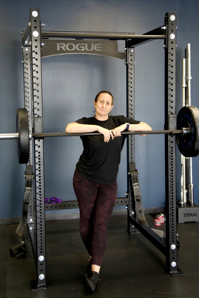 Melissa Schaffer, founder and coach, at the squat rack