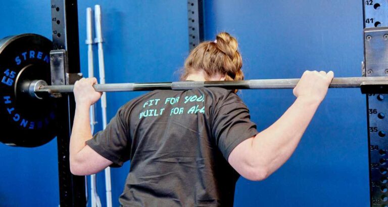 Athlete squatting a barbell at Echo Motion Fitness