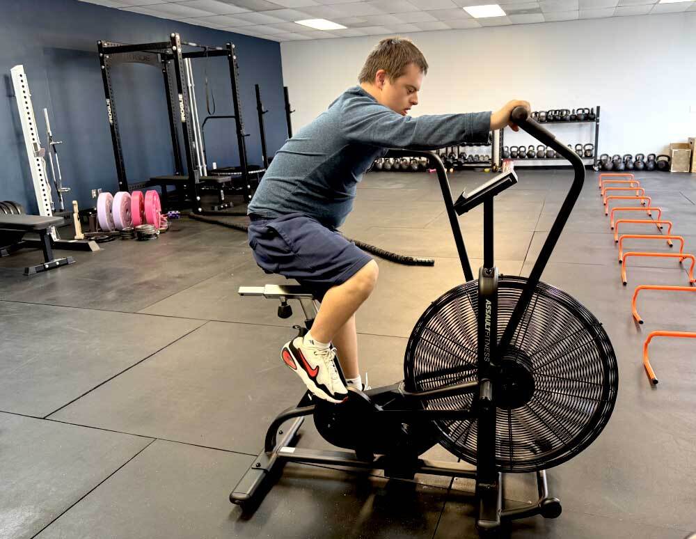 An athlete training on an air bike