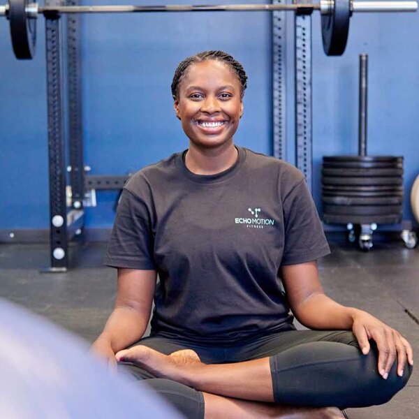 Desiree, Echo Motion Fitness coach, smiling in the gym